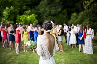 Bride at backyard wedding about to toss bouquet.