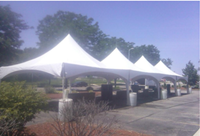 Four high peak tents lined up.